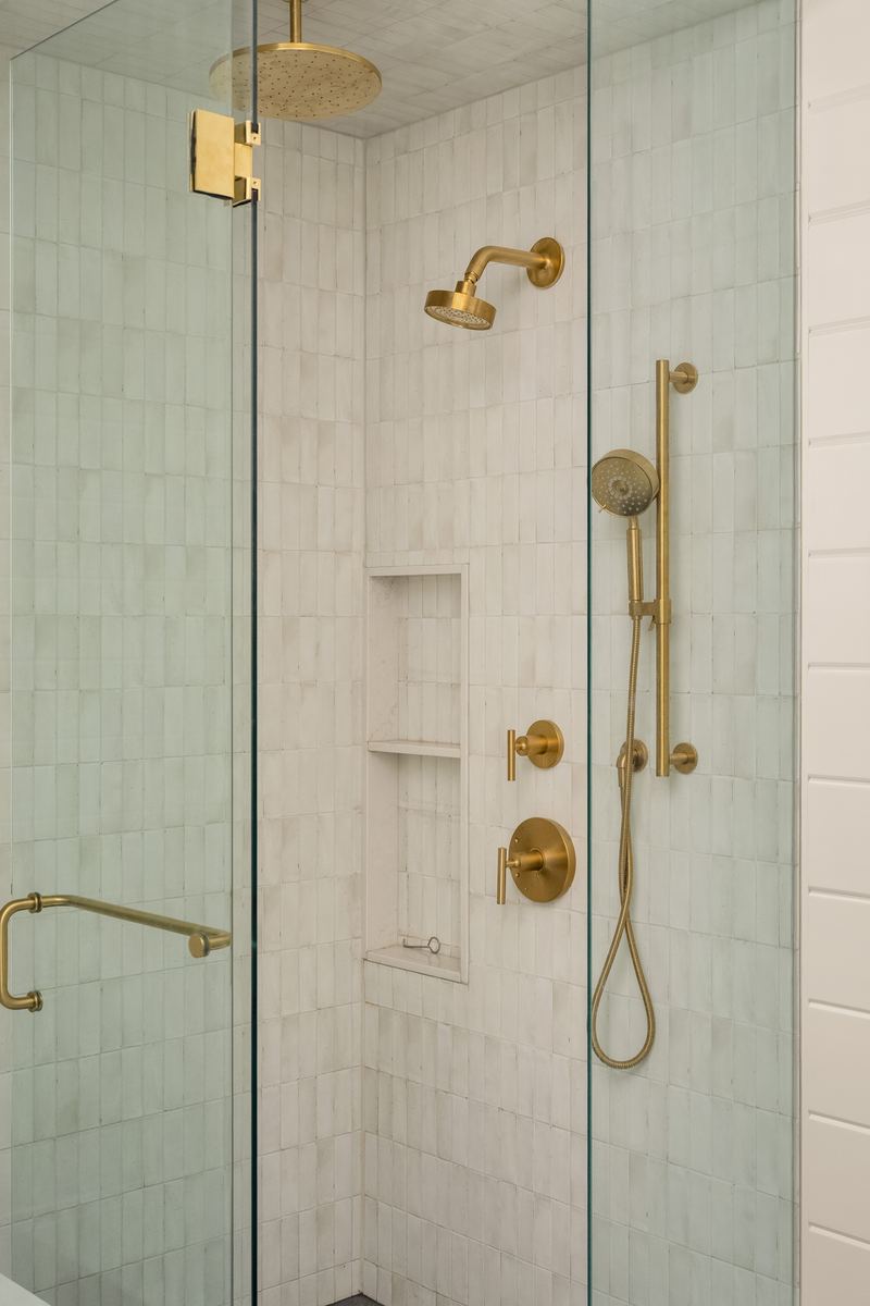 Primary ensuite glass shower with brushed brass fixtures