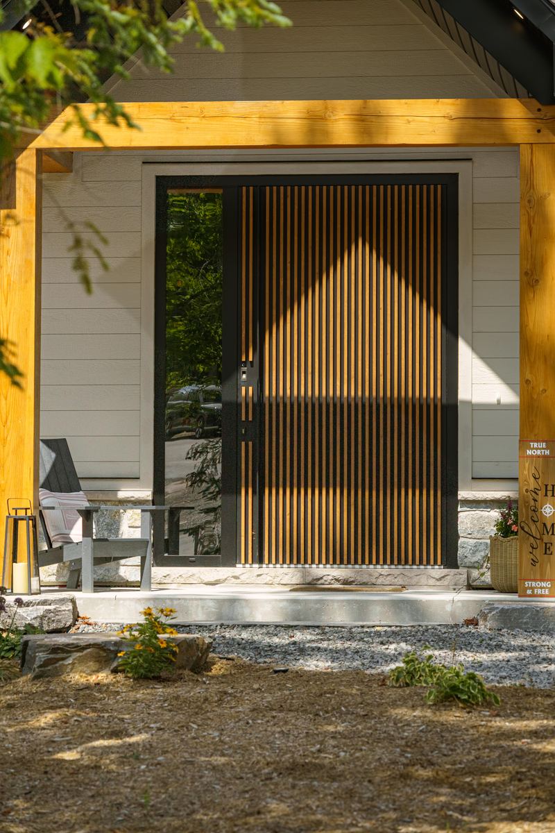 Front door detail, timber post porch and a slatted wood door