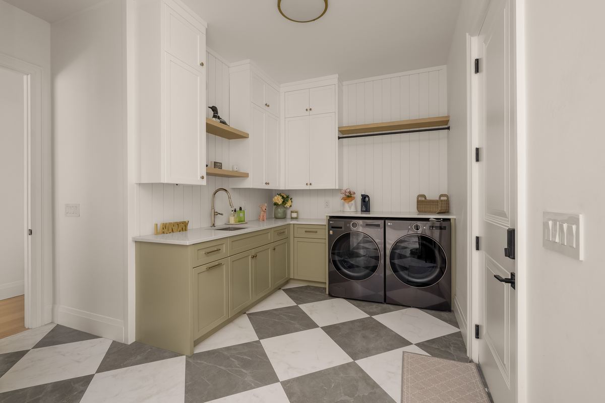 Laundry room with cabinetry, a sink and side-by-side washer and dryer