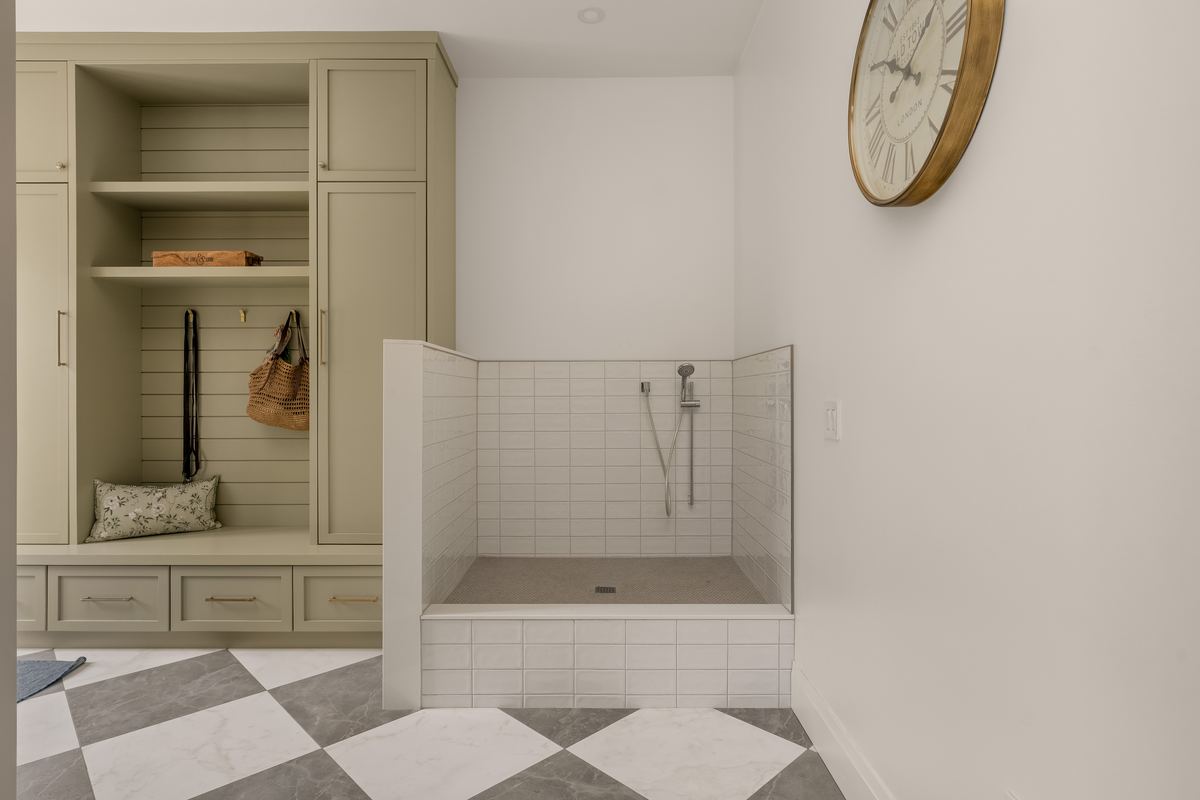 Mudroom with built-in lockers and a tiled dog wash