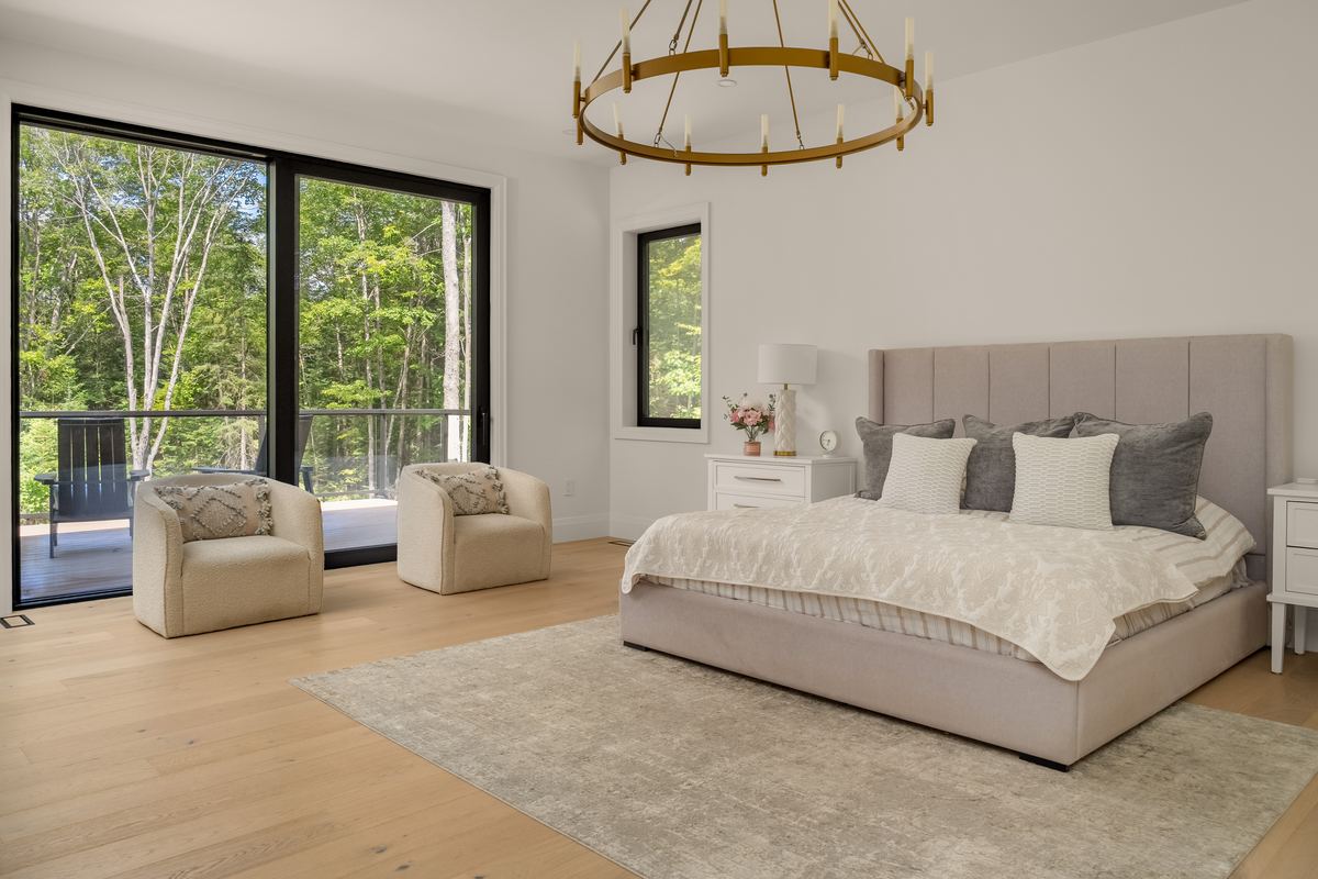Main floor primary bedroom with a walkout to the deck