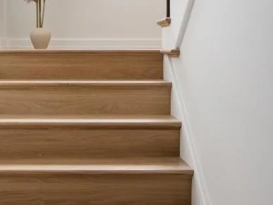 Red oak stair treads and risers with a wood handrail and iron pickets, a Fuller Developments standard