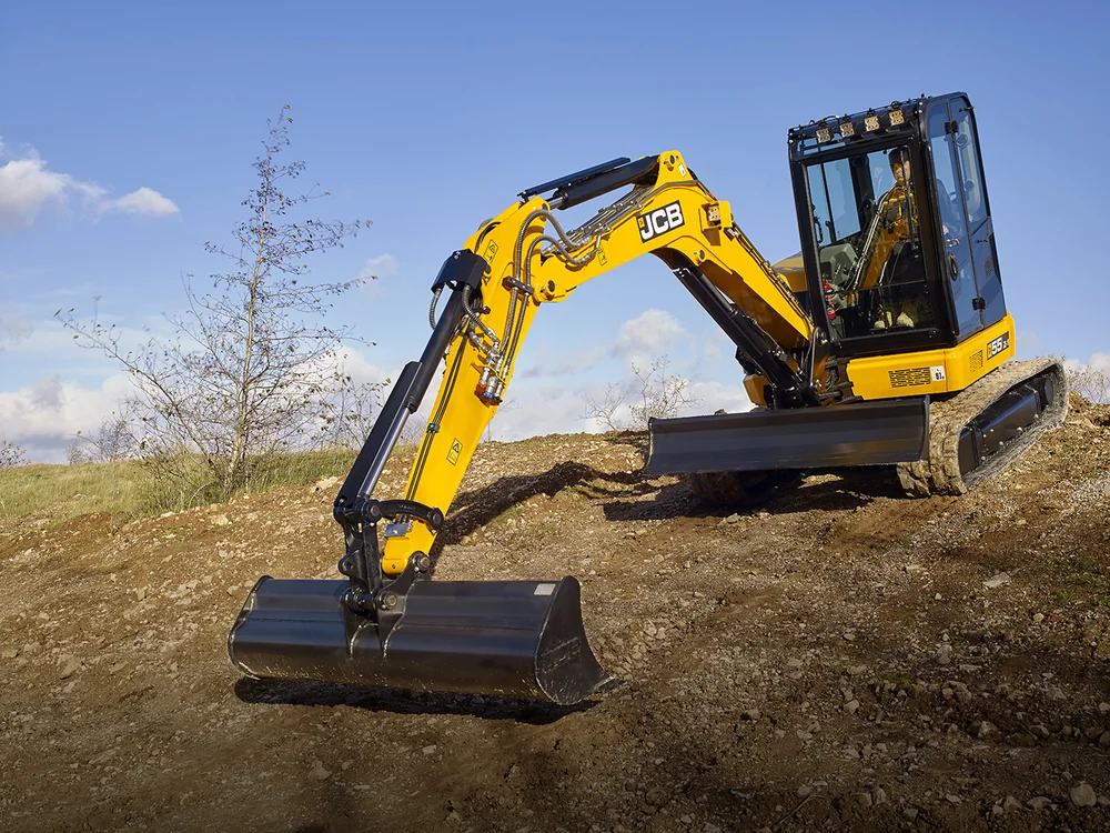 JCB 55Z-1 zero tail swing mini excavator digging on sloping ground