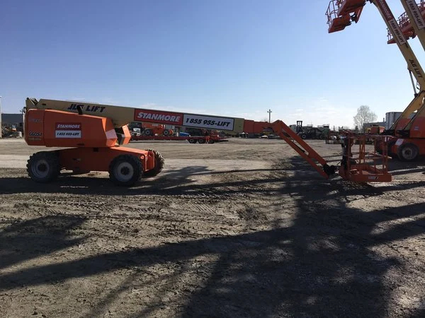 JLG 660SJ telescopic straight boom lift with the boom stowed, at the dealer yard