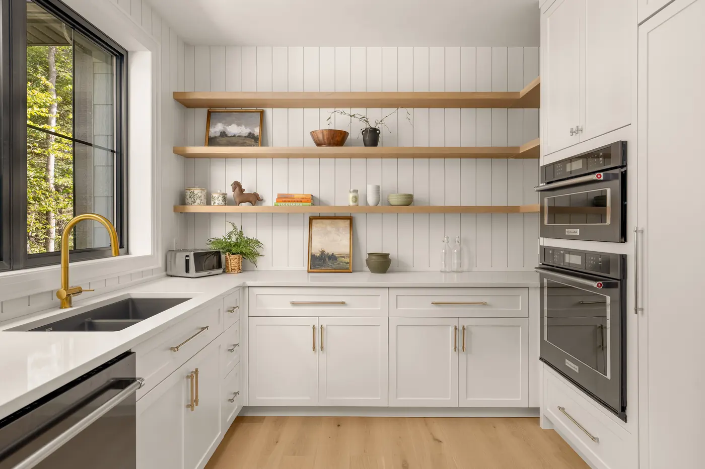 Butler's pantry with open oak shelves and double wall ovens in the Fuller model home, 9 Glen Eagle Court
