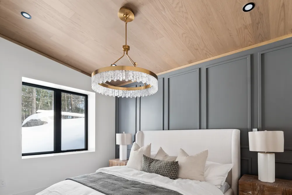 Primary bedroom at Hemlock Point under a wood plank ceiling