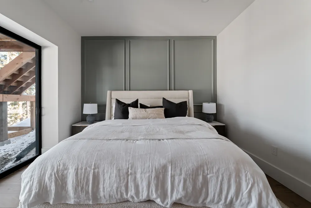 Guest bedroom at Hemlock Point with a sage panelled feature wall