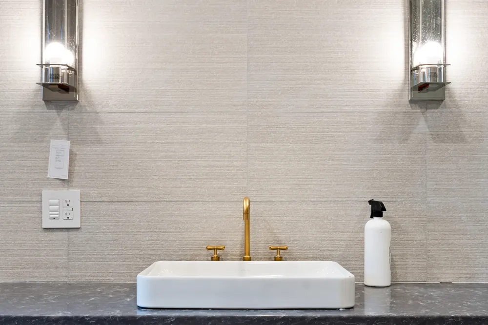 Powder room at Hemlock Point with a vessel basin and brass tap