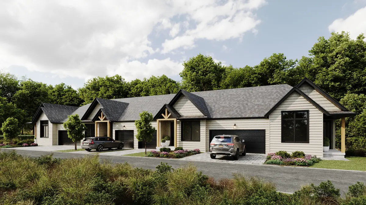 Street view of the Deerhurst townhomes, showing garages, covered porches and timber gable detail